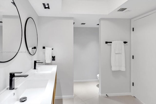 bathroom with tile patterned flooring, vanity, and toilet