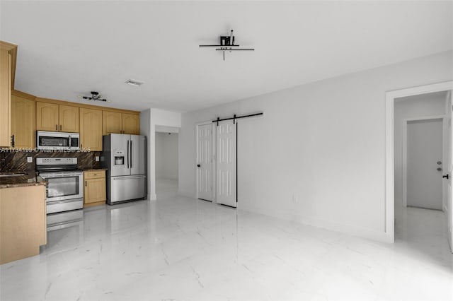 kitchen with stainless steel appliances, a barn door, light brown cabinets, and backsplash