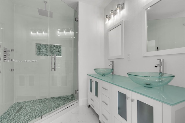 bathroom featuring vanity and a shower with shower door