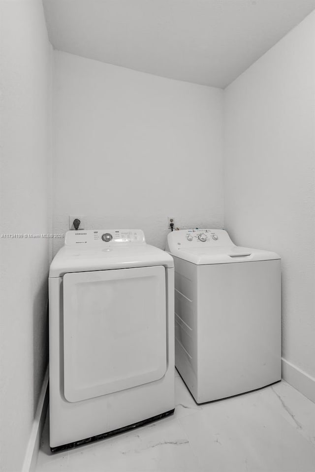 clothes washing area with separate washer and dryer