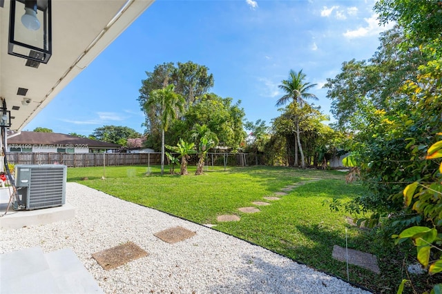 view of yard featuring central AC and a patio