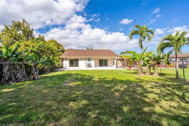 rear view of property with a lawn