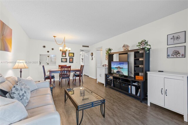 living room with light hardwood / wood-style flooring and a textured ceiling