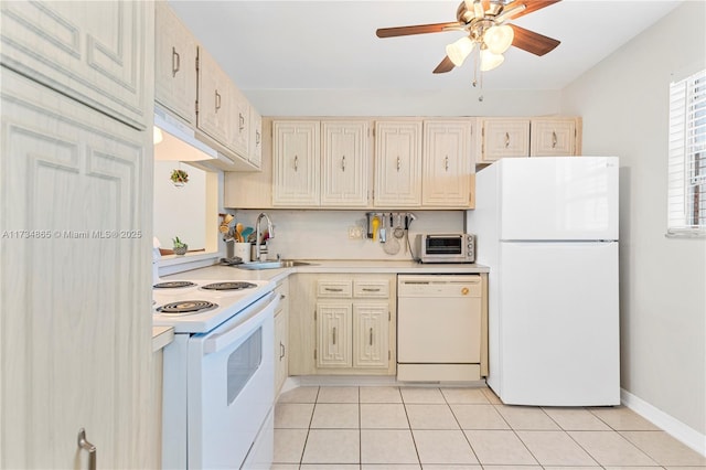 kitchen featuring light tile patterned floors, light countertops, white appliances, and a sink