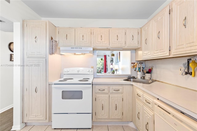 kitchen featuring light countertops, light tile patterned flooring, a sink, white appliances, and under cabinet range hood