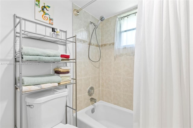 bathroom featuring shower / tub combo and toilet