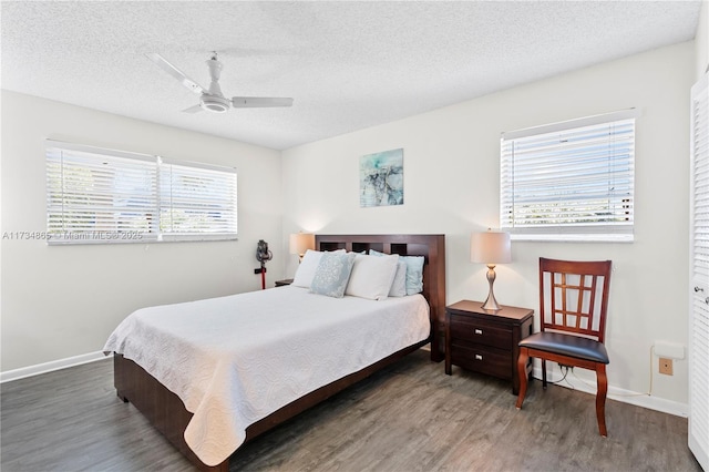 bedroom featuring ceiling fan, baseboards, dark wood finished floors, and a textured ceiling