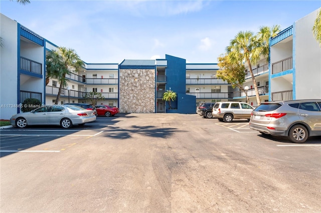 view of building exterior with uncovered parking