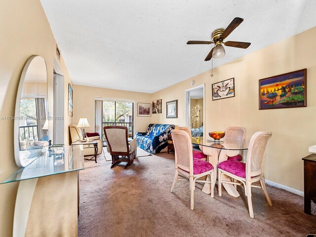 carpeted dining space featuring ceiling fan and a textured ceiling