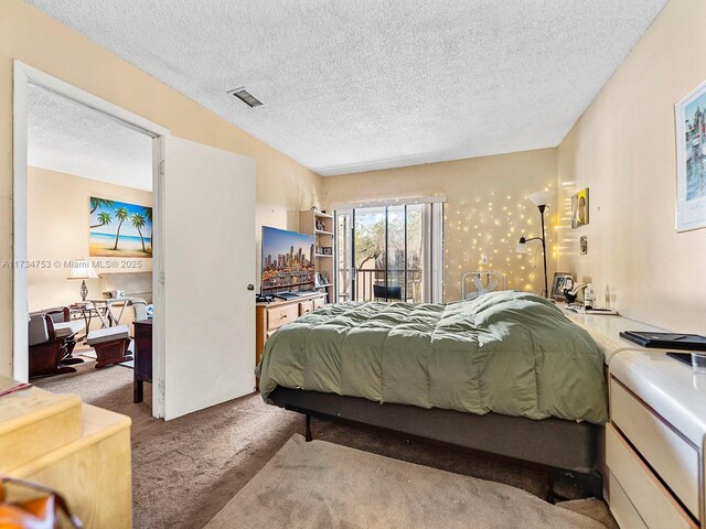 bedroom featuring carpet floors and a textured ceiling