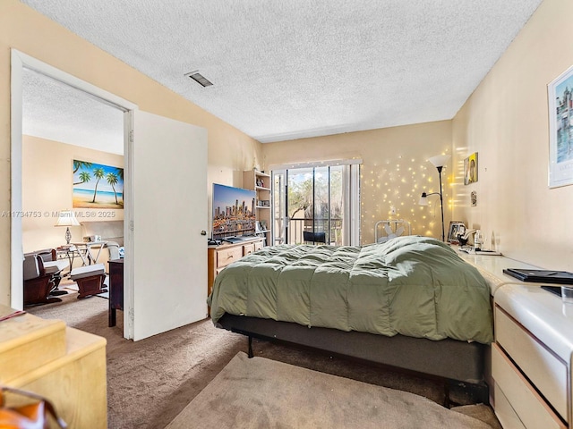 carpeted bedroom with access to exterior and a textured ceiling