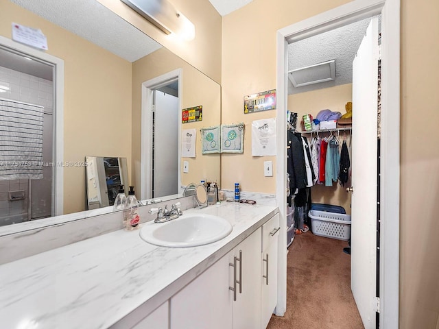 bathroom with vanity and a textured ceiling