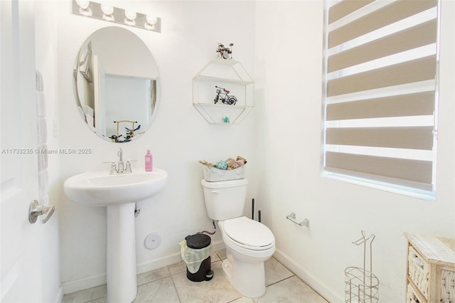 bathroom featuring toilet and tile patterned flooring