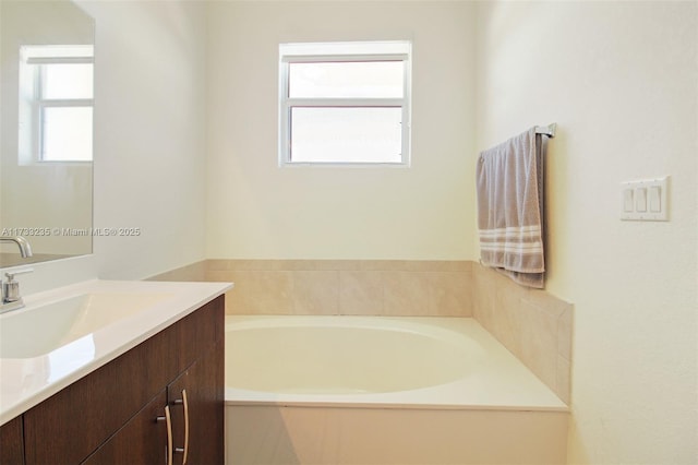 bathroom featuring vanity and a bath