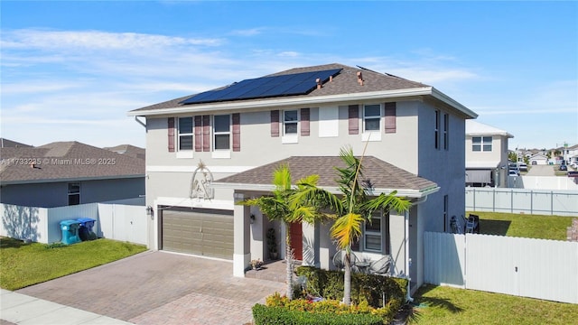 front facade with a garage, a front lawn, and solar panels