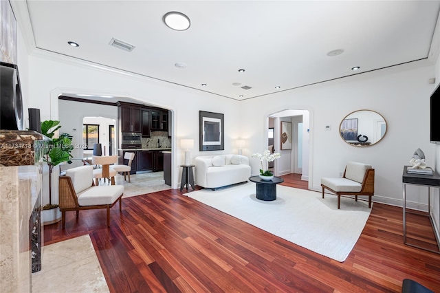 living room featuring hardwood / wood-style floors and ornamental molding