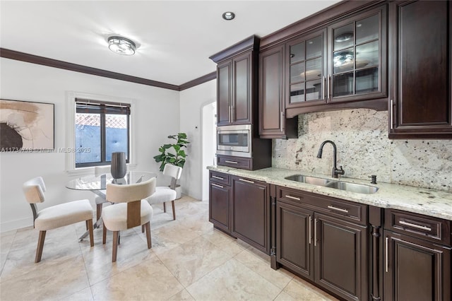 kitchen featuring sink, crown molding, backsplash, dark brown cabinets, and stainless steel microwave