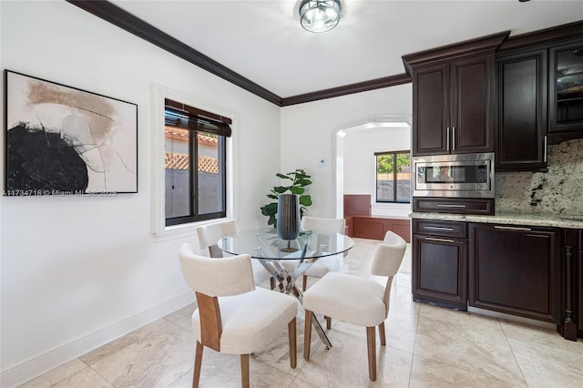 dining space featuring ornamental molding