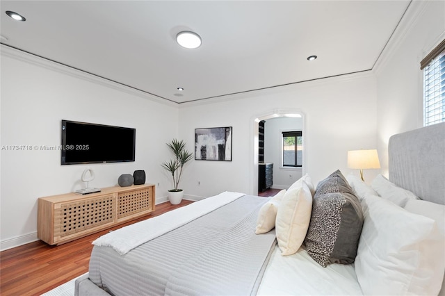 bedroom with crown molding and hardwood / wood-style flooring