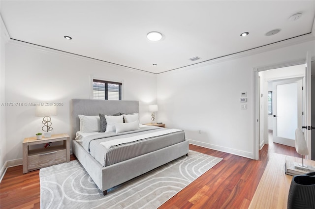 bedroom with crown molding and wood-type flooring