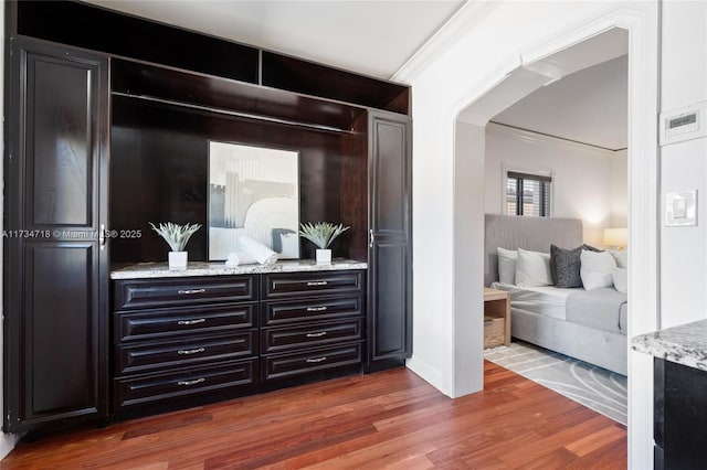 interior space with dark wood-type flooring and crown molding