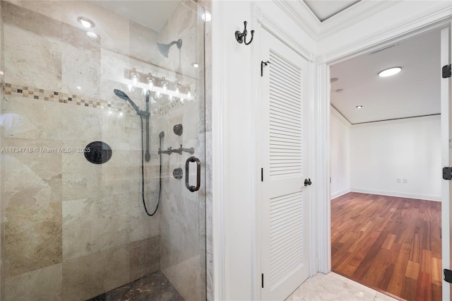 bathroom featuring crown molding, wood-type flooring, and walk in shower