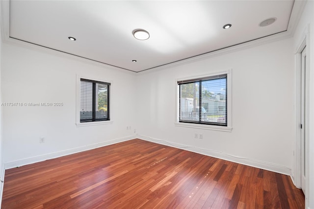 spare room with crown molding and hardwood / wood-style floors