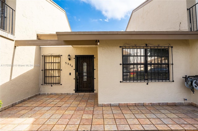 view of exterior entry featuring a patio area