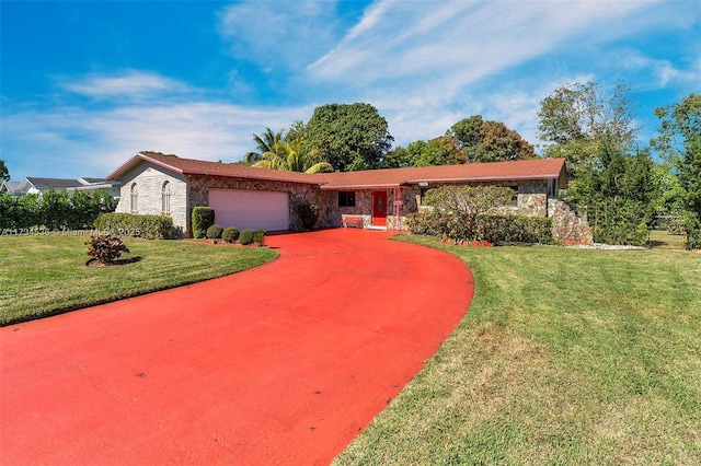 ranch-style home featuring a garage and a front yard