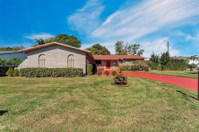 ranch-style home featuring a front yard