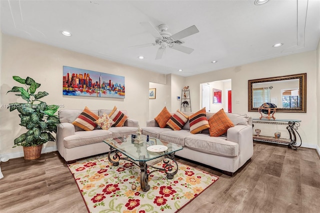 living room featuring wood-type flooring and ceiling fan