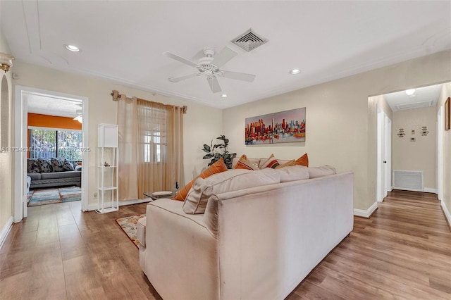 living room featuring wood-type flooring and ceiling fan