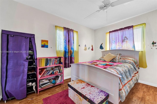 bedroom with wood-type flooring and ceiling fan