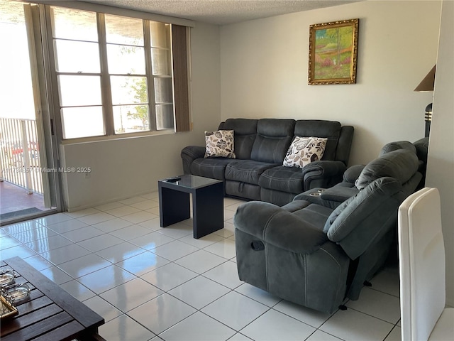 living room with light tile patterned floors and a textured ceiling