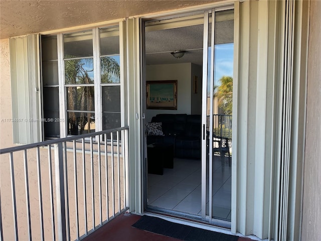 view of exterior entry with a balcony