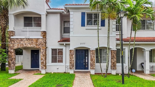 mediterranean / spanish-style home with a front lawn