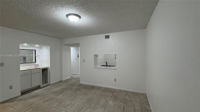 empty room featuring a textured ceiling