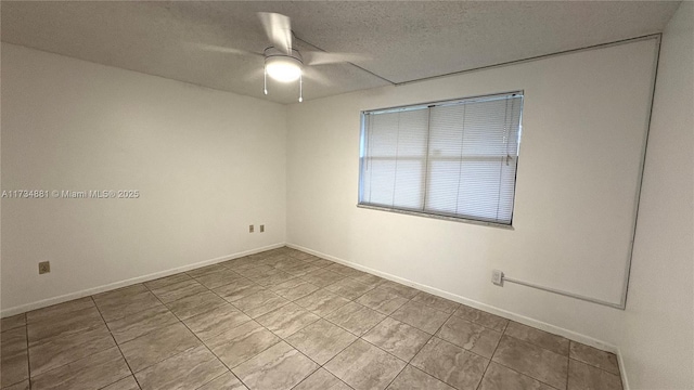 spare room with ceiling fan and a textured ceiling