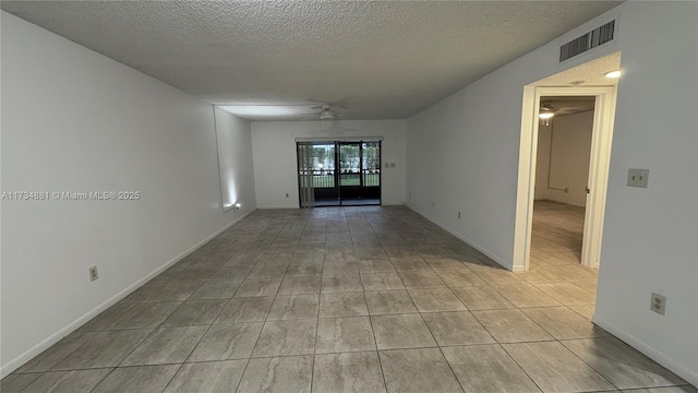 spare room featuring ceiling fan and a textured ceiling