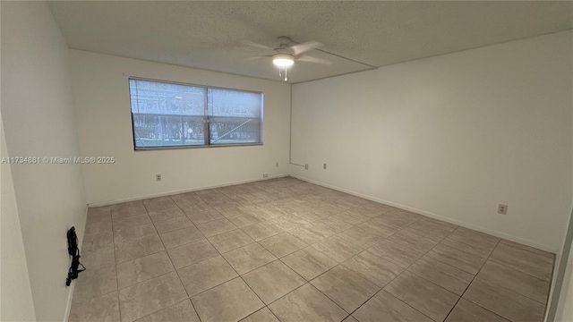 spare room featuring a textured ceiling and ceiling fan