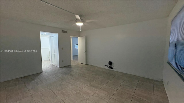 spare room featuring ceiling fan and a textured ceiling