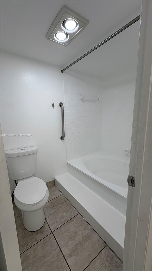 bathroom featuring walk in shower, toilet, and tile patterned flooring