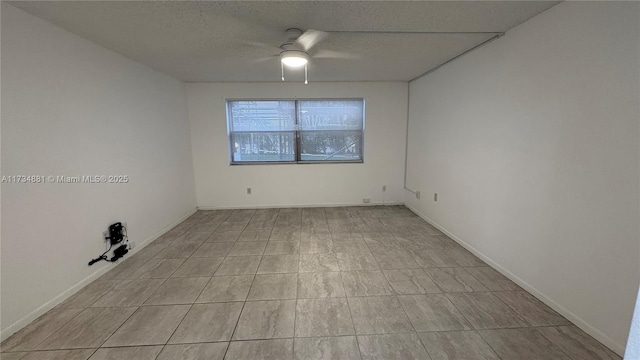 empty room featuring ceiling fan and a textured ceiling