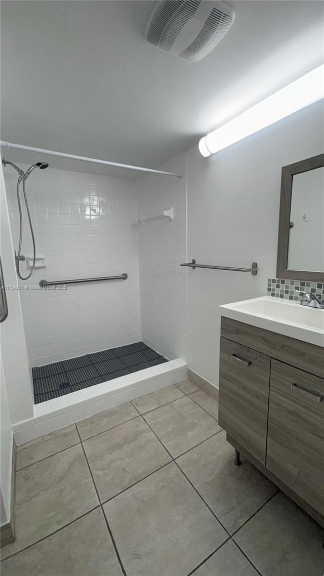 bathroom with vanity, tile patterned floors, and tiled shower