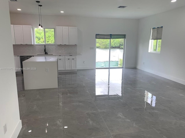 unfurnished living room featuring sink