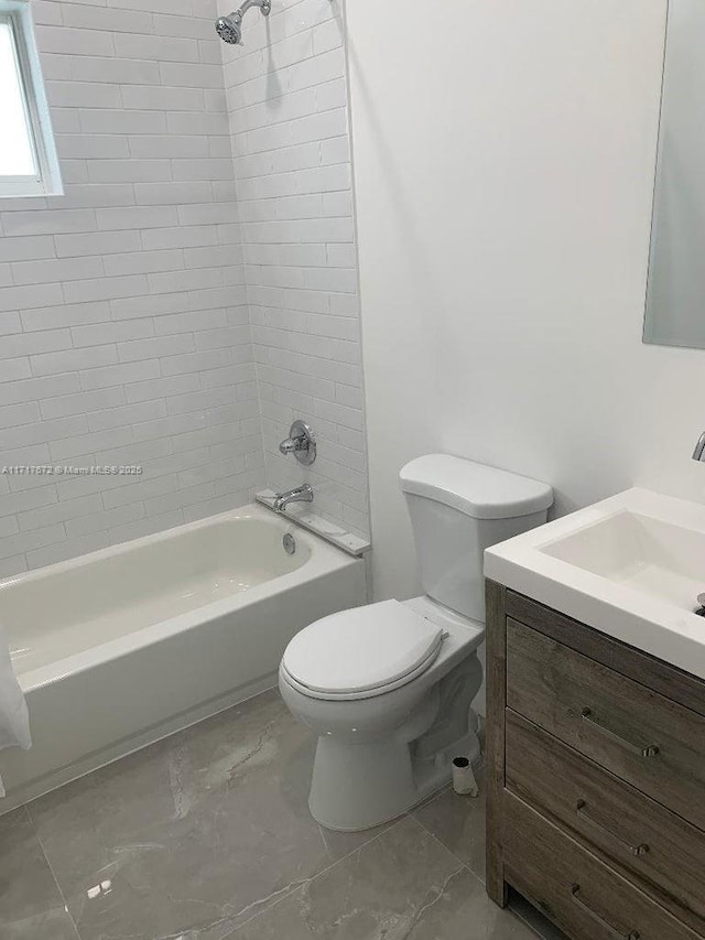 full bathroom with vanity, toilet, and tiled shower / bath combo