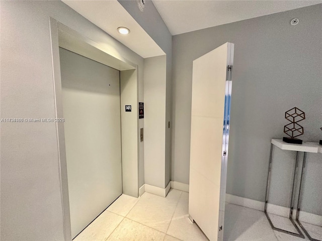 bathroom with tile patterned flooring and elevator