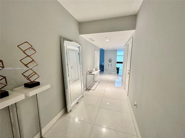 hall featuring light tile patterned floors