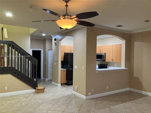 kitchen with light tile patterned flooring, ceiling fan, crown molding, black fridge, and electric stove