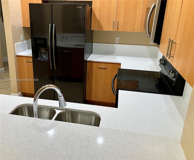 kitchen featuring fridge with ice dispenser, sink, and electric stove